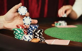 UK Casino Table with Stacks of Chips and Cards