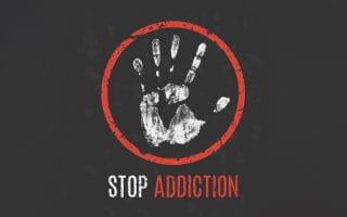 Stop Addiction Sign Under a Handprint in a Red Circle