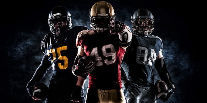 The silhouettes of three football players.