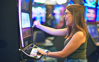 Someone playing a slot machine.